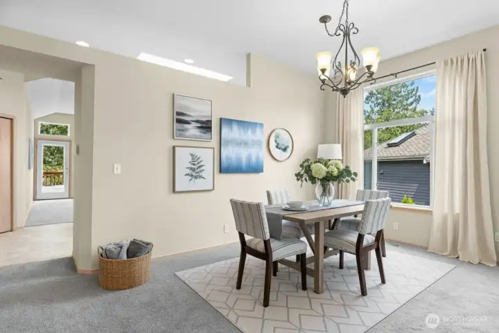 Elegant dining area with room for large gatherings and easy access to the deck for outdoor entertaining.(Virtually Staged)