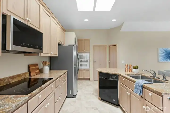 Bright, open kitchen flows seamlessly into the dining and living areas, creating a perfect entertaining space.