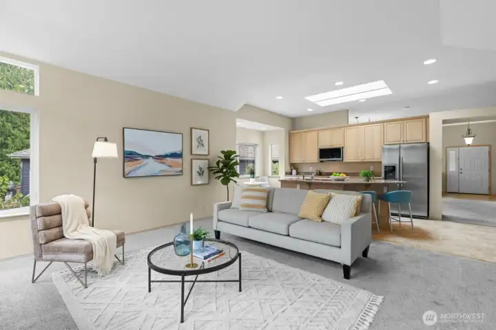 Expansive living room with large windows framing serene forest views and glowing sunsets.(Virtually Staged)