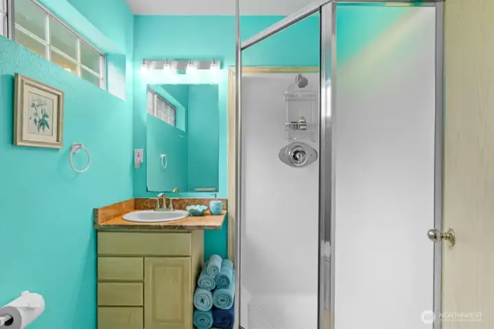 Elegant ensuite bath with walk-in shower. (Virtually Staged )