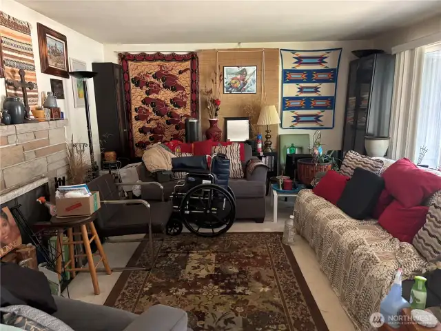 Living room with large picture window and fireplace