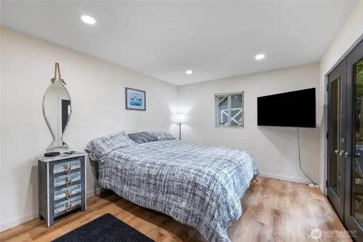Master bedroom French doors lead lower deck for coffee or lazy days watch rain come down.