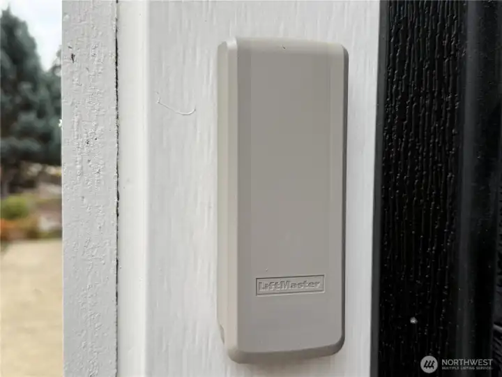 Garage with keyless entry, insulated garage doors, wired for generator and car charging station.