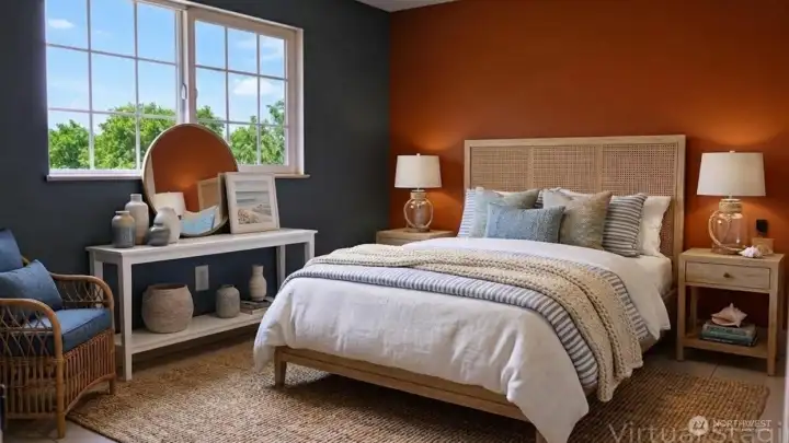 The primary bedroom offers a calm, restful retreat with warm accent walls, soft natural light, and a comfortable layout designed for relaxation.