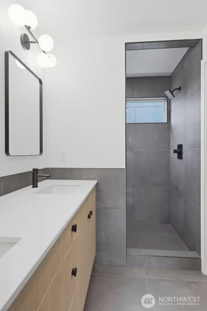 Primary ensuite ¾ bath, a large walk-in tile shower, and a separate toilet room (not pictured).