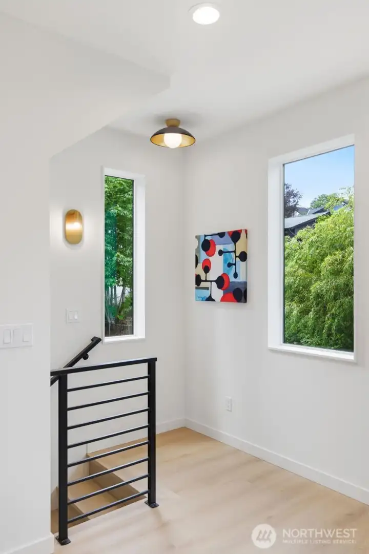 The stairs lead to the entry level, complete with two bedrooms and a full bath. Having the primary suite separate from the other bedrooms is ideal for working from home, guests, or Airbnb homeshares.