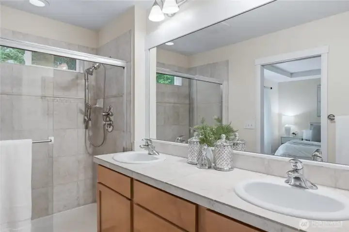 Primary bathroom with dual vanities. Primary bathroom with dual vanities.