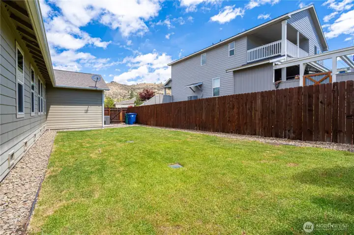Spacious fenced side yard with sprinkler system