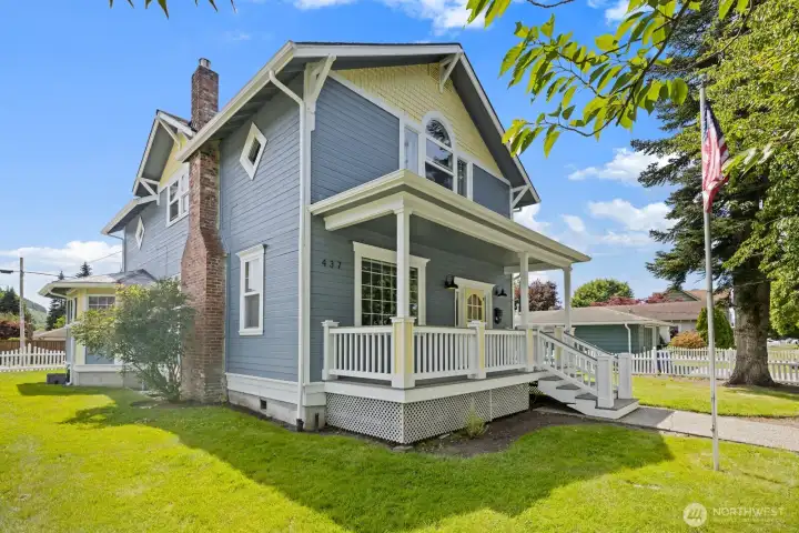 Flag pole, covered porches & curb appeal for miles!