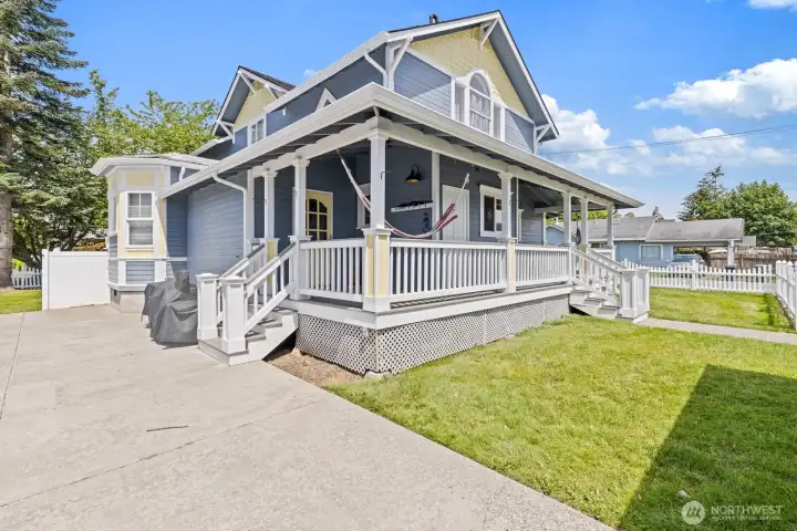 Covered back porch with access to primary bedroom, kitchen & basement.