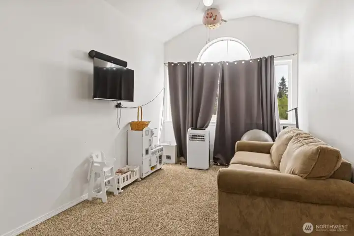 Upper floor additional living/rec/bonus room with vaulted ceilings.