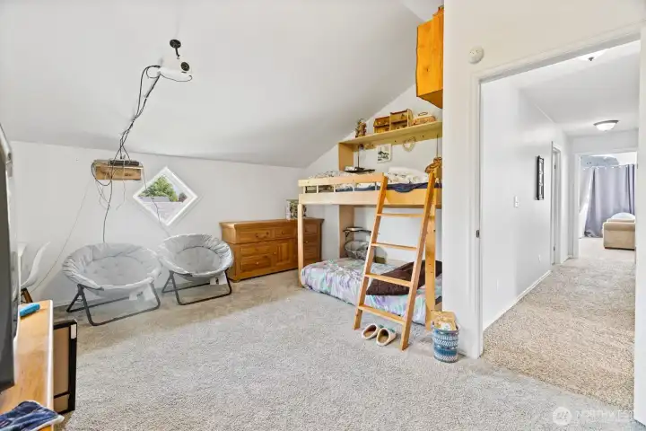 Large upper floor bedroom with vaulted ceilings.