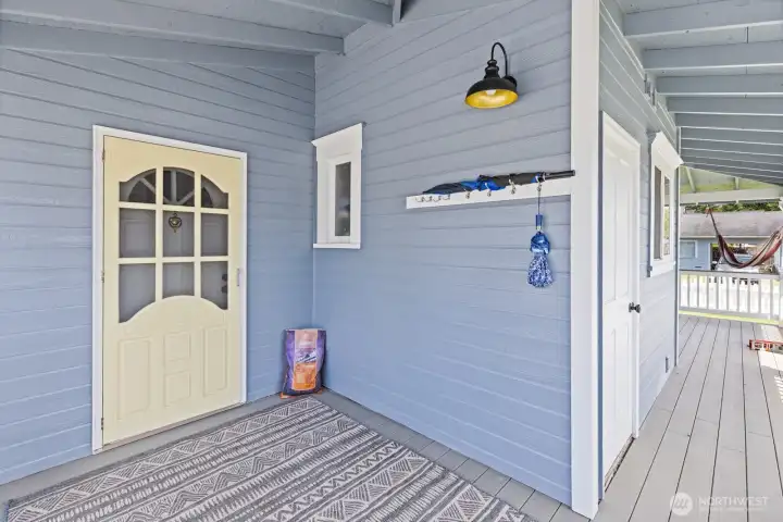 Covered porch entrance to main floor primary bedroom.
