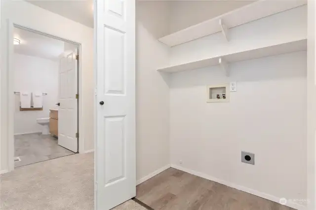 The laundry is in the hallway between the 2 bedrooms