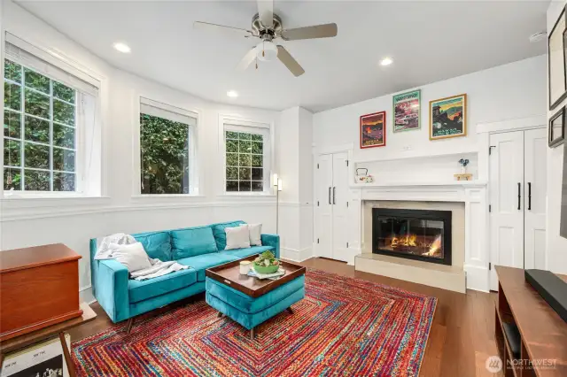 This Living Room with tall ceilings is inviting gas fireplace and an abundance of windows for natrual light. The tall and deep living room cabinets are perfect for storing games, media & entertainment.