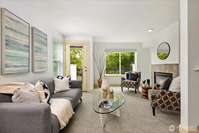 The 2nd floor is where the gathering happens. Spacious living room with gas fireplace and private patio with peek Mt. Rainier views