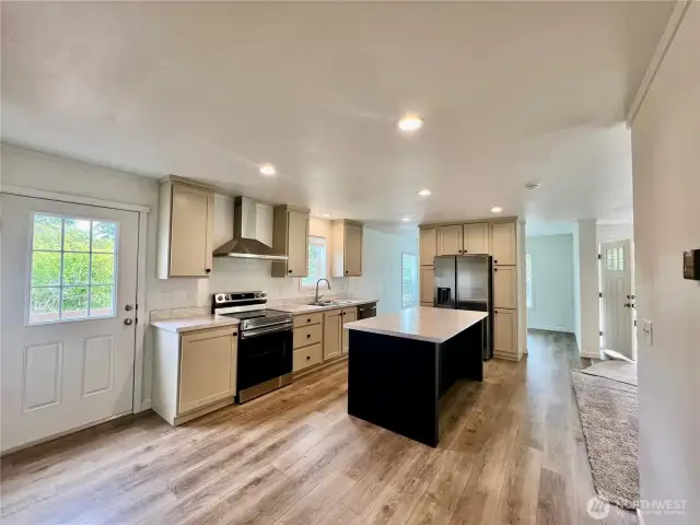 Stainless appliances and large island in kitchen.