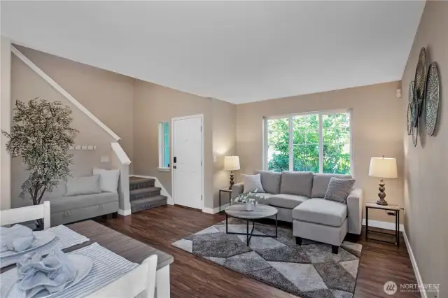 Walking into the home there is a sitting area, and dining area just next to it.