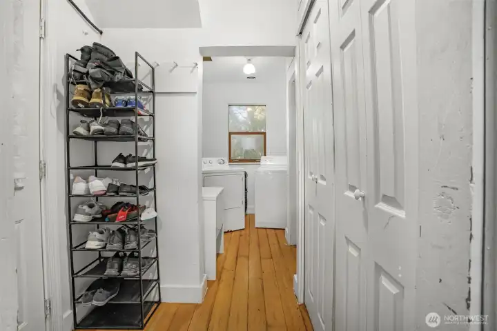 Entry closet and hallway that leads to laundry room