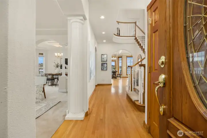 Hardwood entry, dramatic stairway and formal living and dining greets guests.