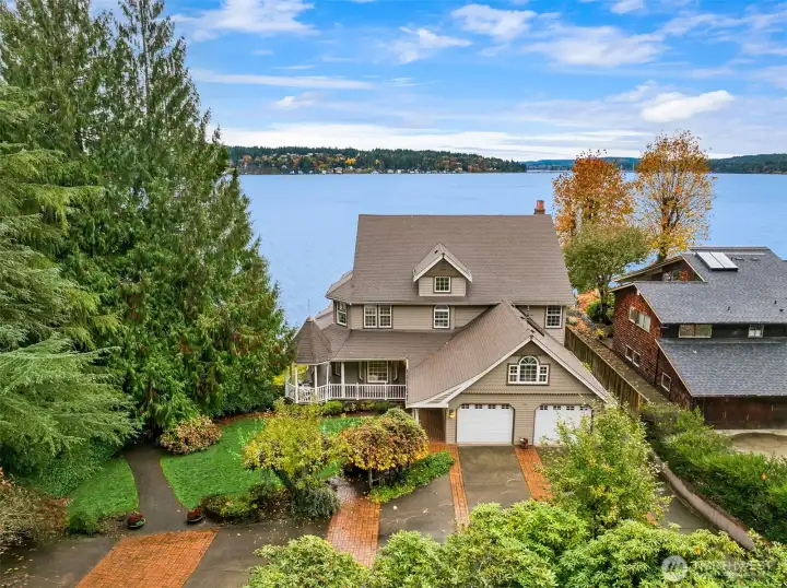 View of garage and wrap around porch.  Lot of parking.