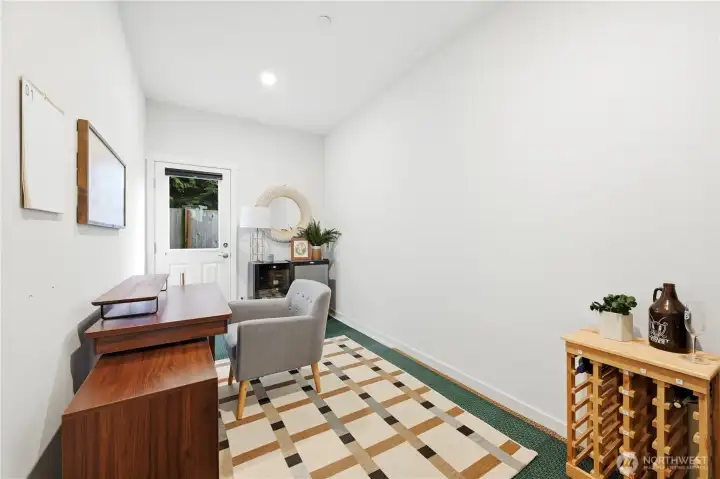 Main floor den/office - great flex space for home gym or wine room - with access to back yard