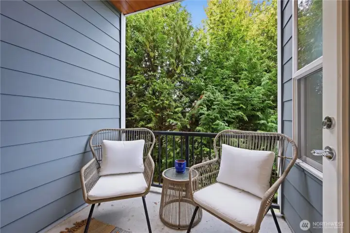 Covered deck backs to trees creating a beautiful and private experience