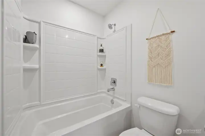 Not pictured as a large linen closet behind the door to this bathroom