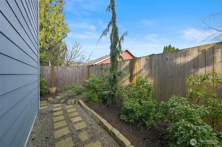 Fully fenced back yard with raised planter beds