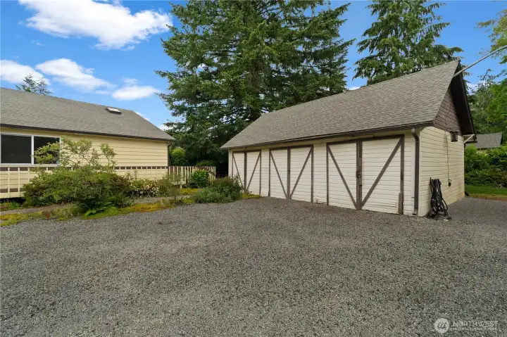A vintage 3-car garage complete with standing-height attic storage, plus additional outbuildings including a horse barn or storage building, chicken coop, and garden shed. A vintage 3-car garage complete with standing-height attic storage, plus additional outbuildings including a horse barn or storage building, chicken coop, and garden shed.