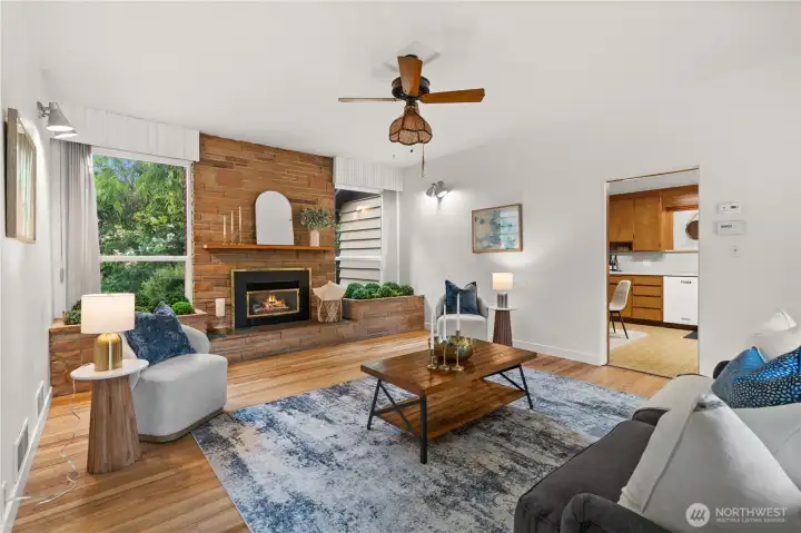 The living room features a gas fireplace with adjacent garden boxes - a very mid-century vibe! Hardwood floors have just been refinished and they are gorgeous! The living room features a gas fireplace with adjacent garden boxes - a very mid-century vibe! Hardwood floors have just been refinished and they are gorgeous!