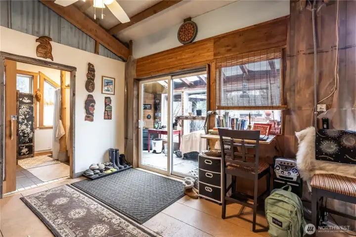 Enjoy effortless indoor-outdoor flow via the sunroom's sliding glass door, while the bathroom offers a discreet pocket door entrance