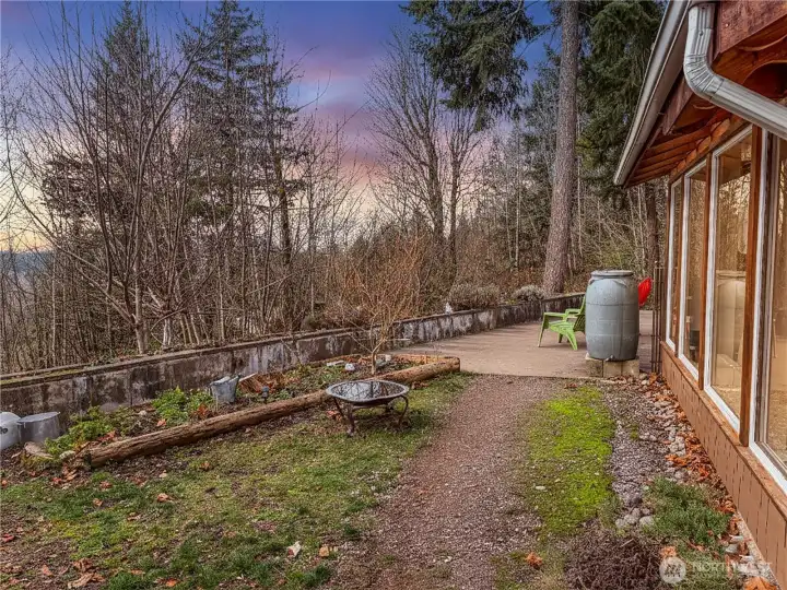 Front patio with established culinary herbs and strawberry beds