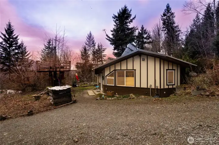 The cabin is surrounded by established bulbs and perennials plantings ready to bloom