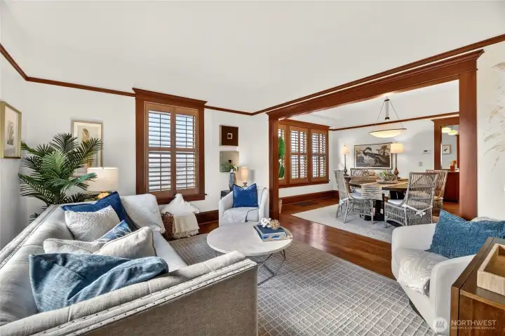 Gorgeous formal living room with plantation shutters, wood moulding and picture rail.