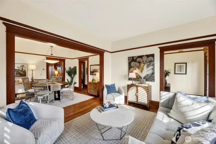 Living room open to the dining room with a large cased opening for a spacious feel.