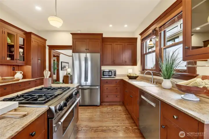 Chef's kitchen with stainless appliances, granite counters and Rejuvenation lighting.