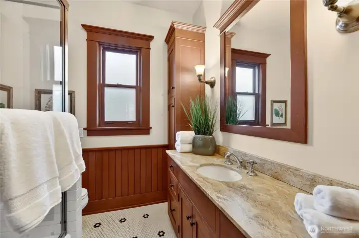 Spacious bathroom with hex tile and lots of storage.