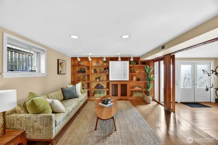 The family room is quite spacious with built in bookcases and  bamboo flooring.