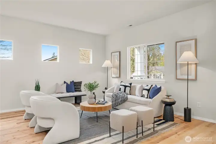 Formal living room off entry has western clerestory windows that dapple the space with afternoon and evening sunlight. The mature trees offer additional privacy.