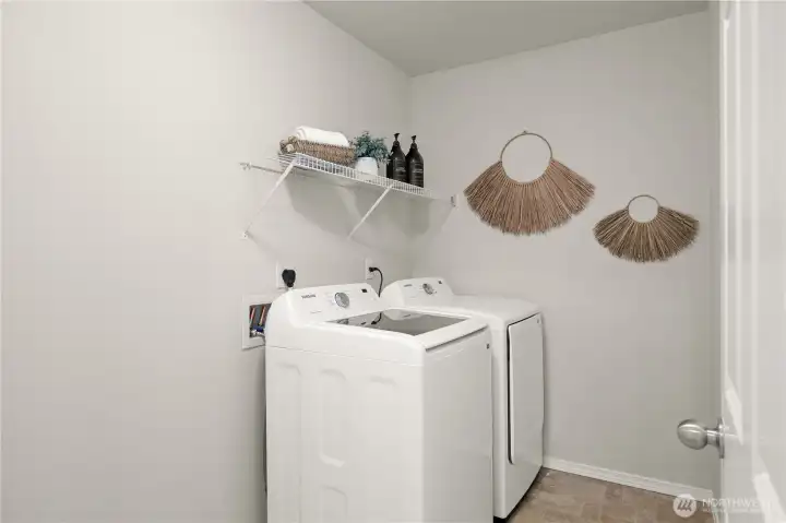 Upper level laundry room with additional storage space.