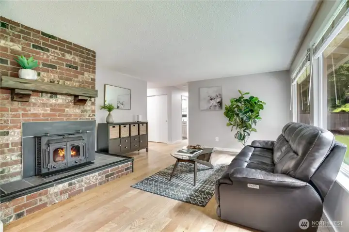 Warm and welcoming living room featuring a charming wood-burning fireplace