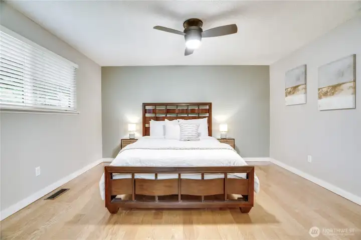 Comfortable primary suite featuring a walk-in closet and private half bath
