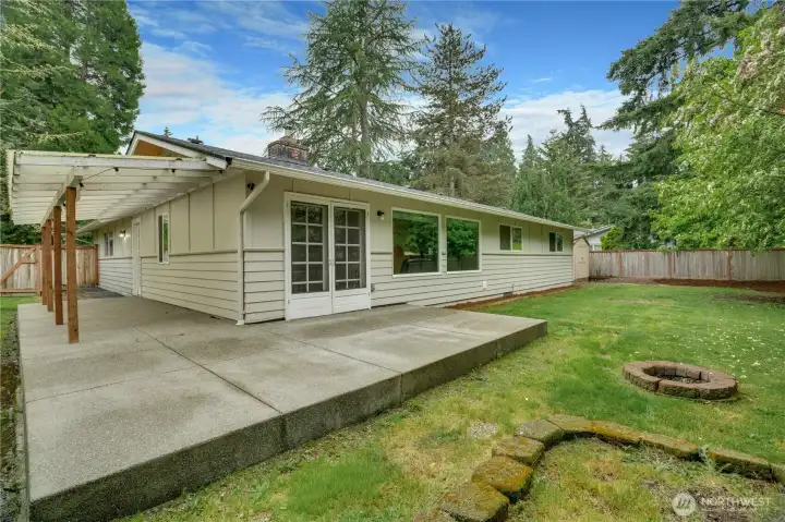 Expansive wraparound patio with partial cover, perfect for year-round entertaining