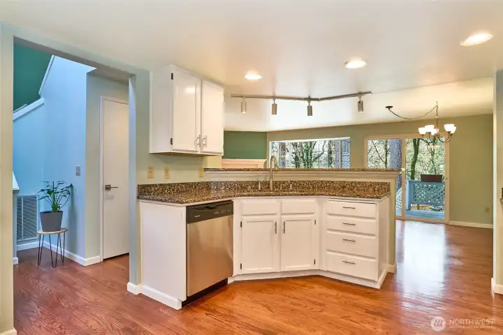 remodeled open kitchen offers a lot of cabinets, drawers and granite counter tops.