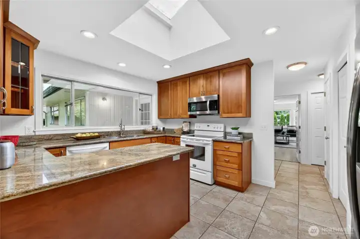 Functional Kitchen with granite counters and cherry cabinets.