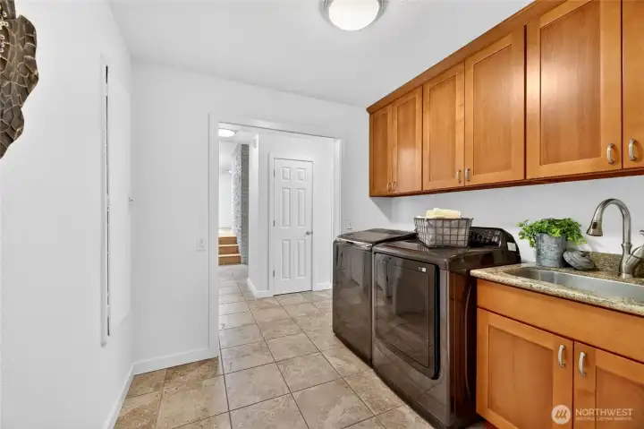 Laundry space with counter, sink and storage.