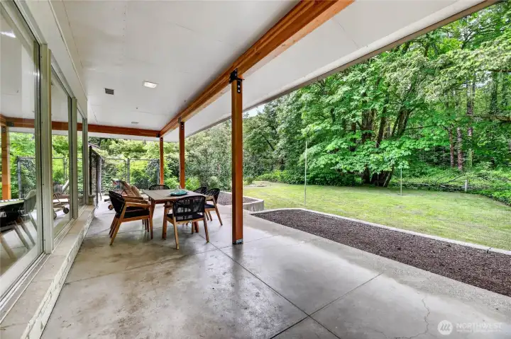 Large covered outdoor patio and sunny garden space.
