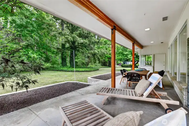 Another view of the very ample patio with steps to your backyard paradise.