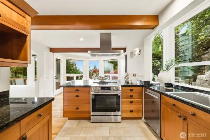 The gourmet kitchen seamlessly connects to multiple outdoor decks, creating the perfect setting for al fresco dining, entertaining, or simply unwinding while enjoying the surrounding beauty.